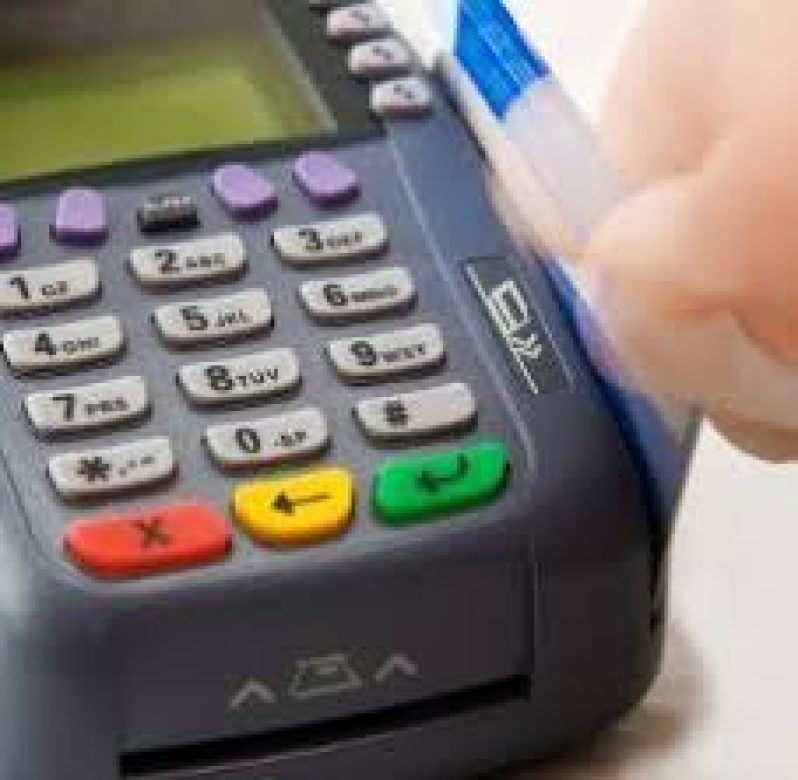 credit card being swiped through machine