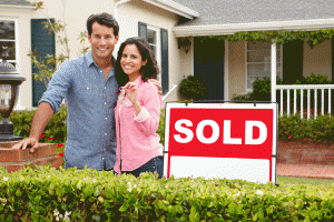 Man and woman in front of a house