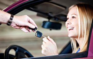 woman being handed a key